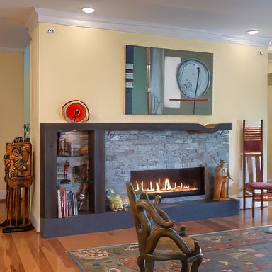 This one of a kind reclaimed oak mantel features a dip on the edge of the fireplace. - E.T. Moore Custom Home