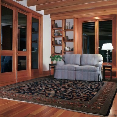 The heart pine doors, trim, bookshelf in this library lend a feeling of warmth to the room. - E.T. Moore Custom Home