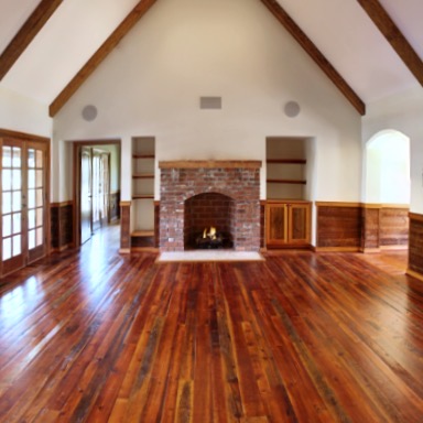 The Great Room's Original Finish Heart Pine Flooring, Hand Hewn Heart Pine Mantels and Reclaimed Beams created the perfect space for the homeowners. - E.T. Moore Custom Home