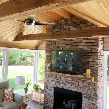 The beams, mantel and ceiling blend flawlessly together in this outdoor space. - E.T. Moore Custom Home