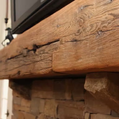This rustic heart pine mantel exudes timeless charm and natural warmth, making it a stunning centerpiece for any living space. Crafted from the reclaimed heartwood of longleaf pine, this mantel showcases rich, deep hues of amber and golden brown, often accented by unique grain patterns, knots, and nail holes that tell a story of its history. The wood’s dense and durable nature ensures longevity, while its weathered texture adds a sense of authenticity and character. Perfect for farmhouse-style homes, cabins, or spaces that embrace organic elements, a heart pine mantel brings a cozy, inviting atmosphere and serves as a striking display for décor, family heirlooms, or seasonal accents. - E.T. Moore Custom Home