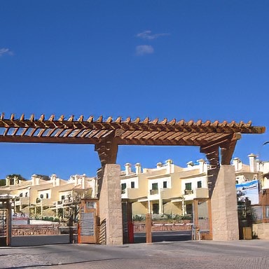 Heart Pine pergola at the Santa Eulalia Hotel Real, a 5 star resort in the southern Algarve province of Portugal. This southern European vacation destination is owned by Senior Gomez, whose construction company built the hotel; his own mill employed artisans who handcrafted all the furniture in the hotel! Seventeen containers of reclaimed antique heart pine were shipped from E.T. MooreÂ’s plant in Richmond, Virginia, through the port of Norfolk to Lisbon for this job. Our antique wood, used for this pergola, the main gates, doors of the villas, and furniture, helps maintain the rustic theme Sr. Gomez achieved throughout the resort. - E.T. Moore Custom Home