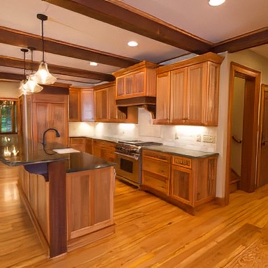This Custom Kitchen is a perfect blend our reclaimed flooring, mouldings, and beams. Many of the elements from the original finish beams, to the wormy chestnut cabinet panels, copper hood vent, and granite countertops makes this space inviting for homeowners and guest alike. - E.T. Moore Custom Home